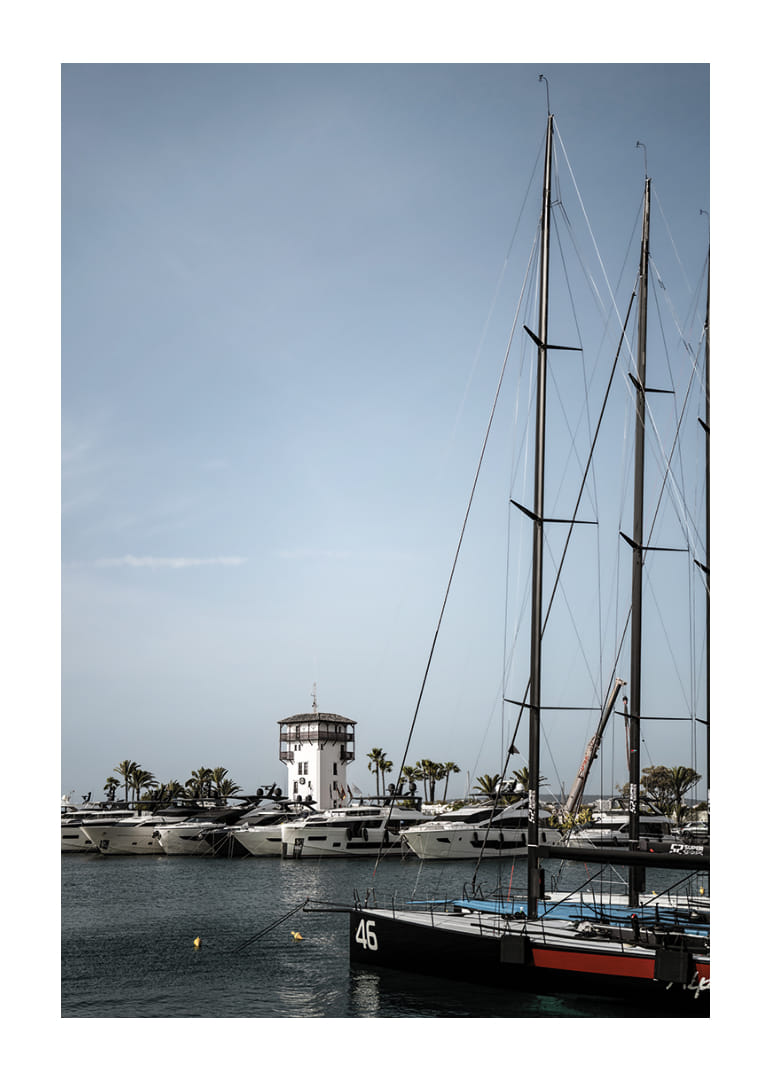 A quiet harbor with elegant masts against a clear sky.-12