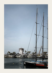 A quiet harbor with elegant masts against a clear sky.-3