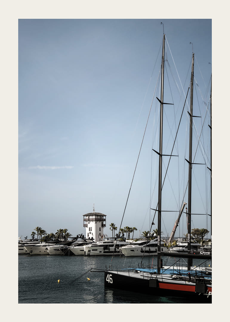 A quiet harbor with elegant masts against a clear sky.-12