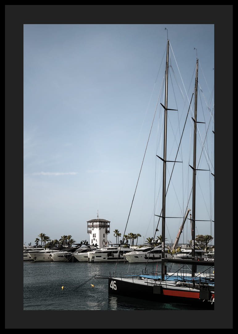A quiet harbor with elegant masts against a clear sky.-12