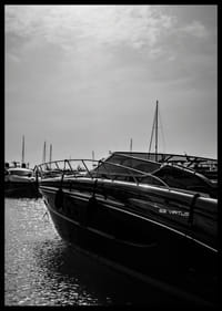 Silhouettes of boats in a calm water landscape.-6
