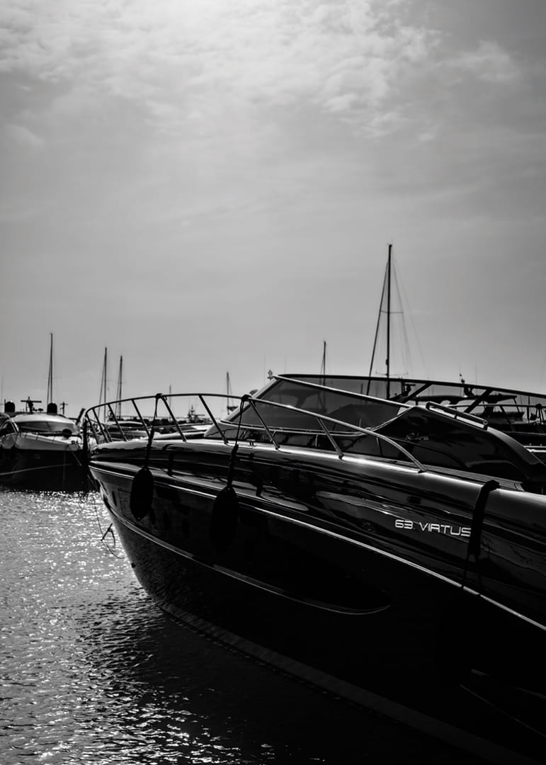 Silhouettes of boats in a calm water landscape.-12