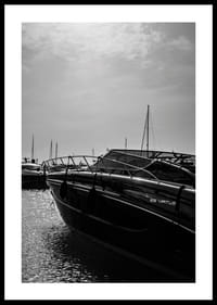 Silhouettes of boats in a calm water landscape.-0