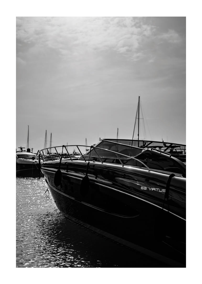 Silhouettes of boats in a calm water landscape.-12