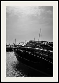 Silhouettes of boats in a calm water landscape.-2