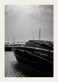 Silhouettes of boats in a calm water landscape.-3
