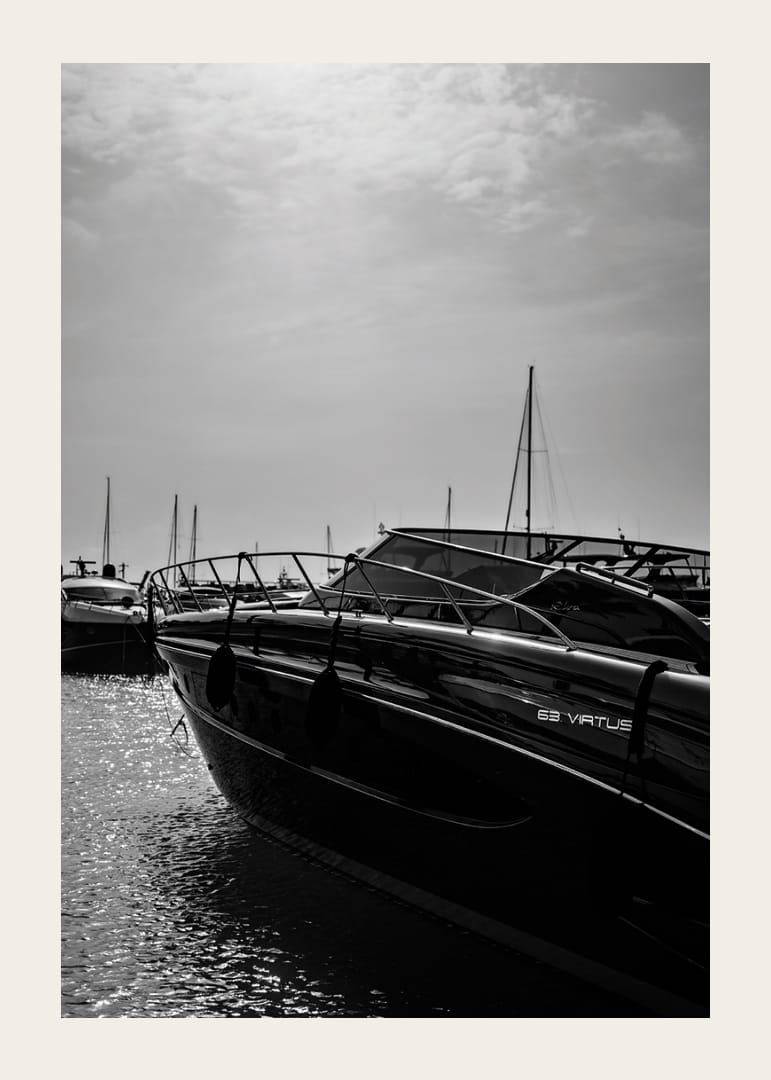 Silhouettes of boats in a calm water landscape.-12