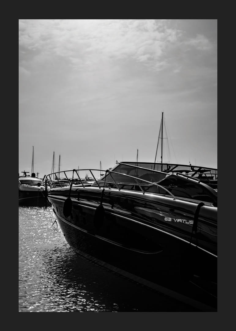 Silhouettes of boats in a calm water landscape.-12