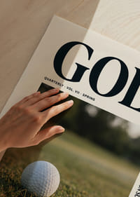 A golf ball rests near the hole in the golden grass.-3