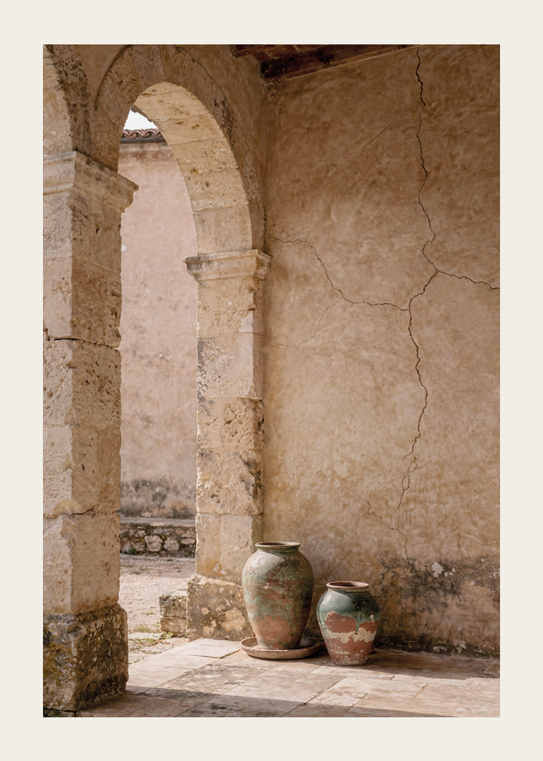 Two rustic pots rest under a timeless stone arch.-12