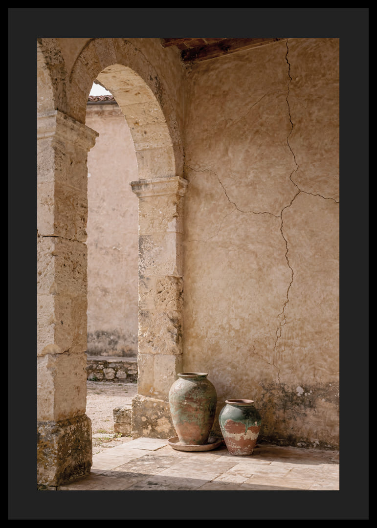 Two rustic pots rest under a timeless stone arch.-12