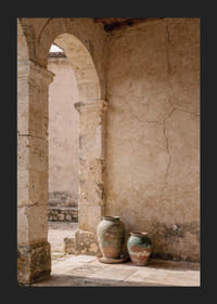 Two rustic pots rest under a timeless stone arch.-5