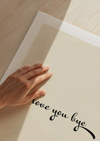 Playful handwritten love greeting in black against a warm beige background.-9