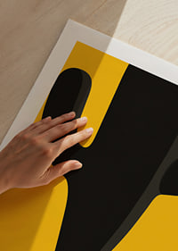 A small cactus casts a monumental, playful shadow against a yellow background.-9