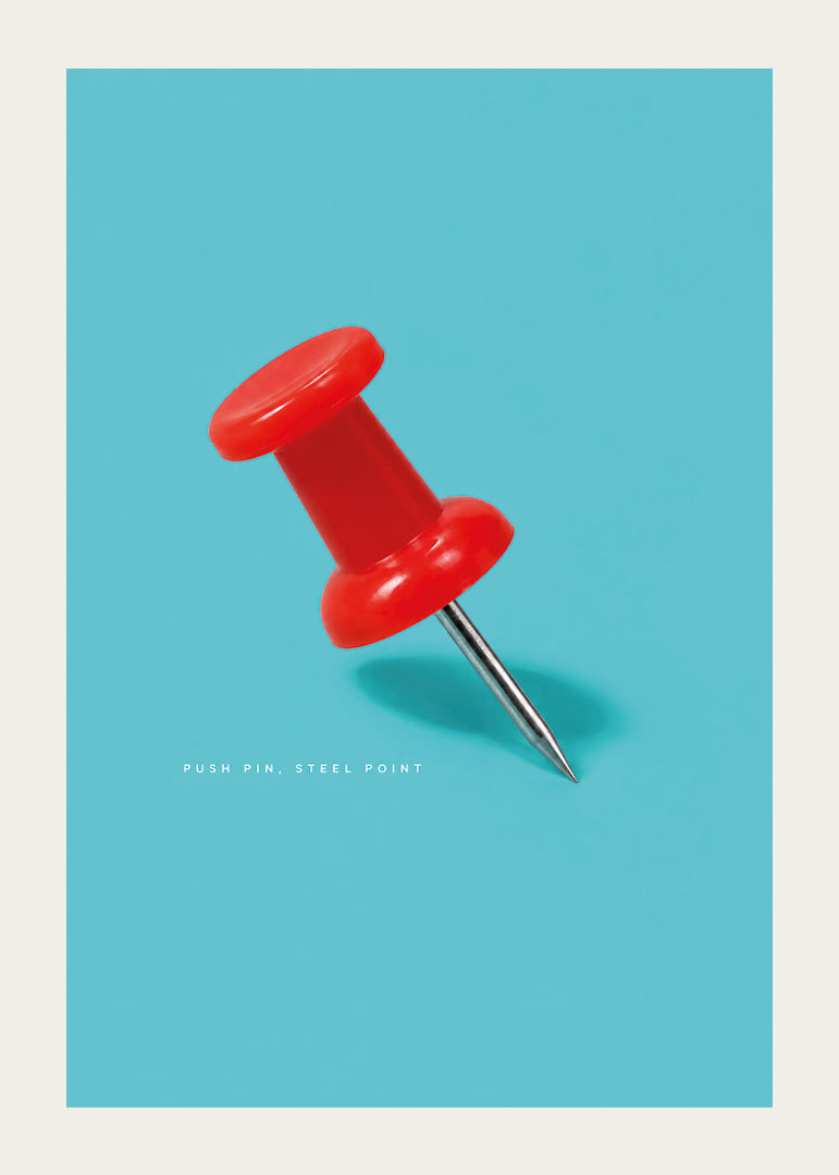 A shiny red pushpin against a turquoise background with a playful graphic feel.-12