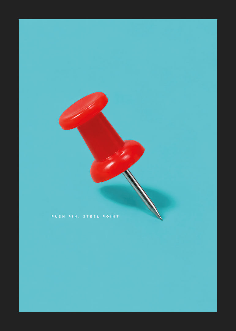 A shiny red pushpin against a turquoise background with a playful graphic feel.-12