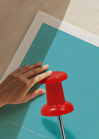 A shiny red pushpin against a turquoise background with a playful graphic feel.-9