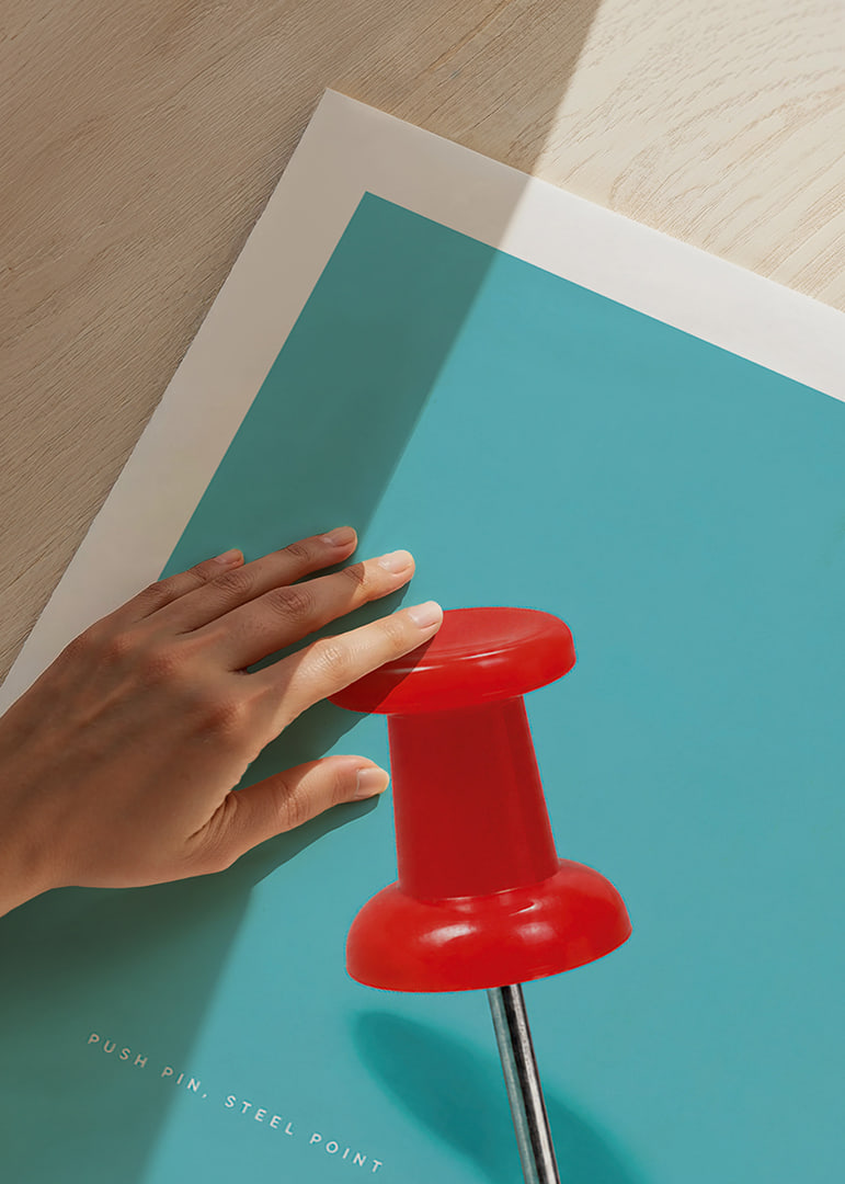 A shiny red pushpin against a turquoise background with a playful graphic feel.-12