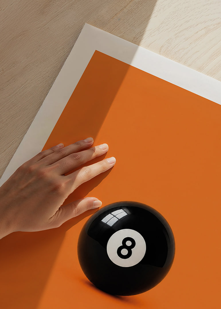 A shiny black eight-ball against an intense orange background with confident energy.-12