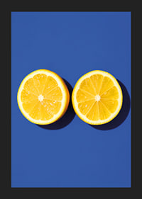 Two sunny yellow lemon halves shine against a deep blue background with fresh energy.-5