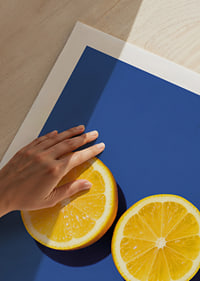 Two sunny yellow lemon halves shine against a deep blue background with fresh energy.-9