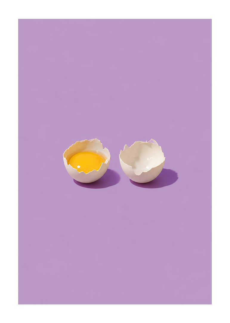 A golden egg in cracked shell against a purple background with a playful, stylish feel.-12