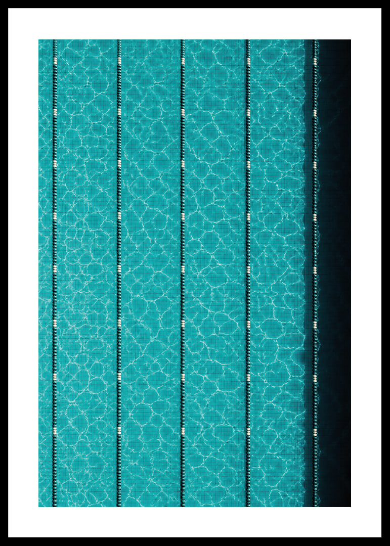 Turquoise pool water and dark track lines create a cool, graphic rhythm.-12