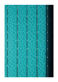 Turquoise pool water and dark track lines create a cool, graphic rhythm.-1