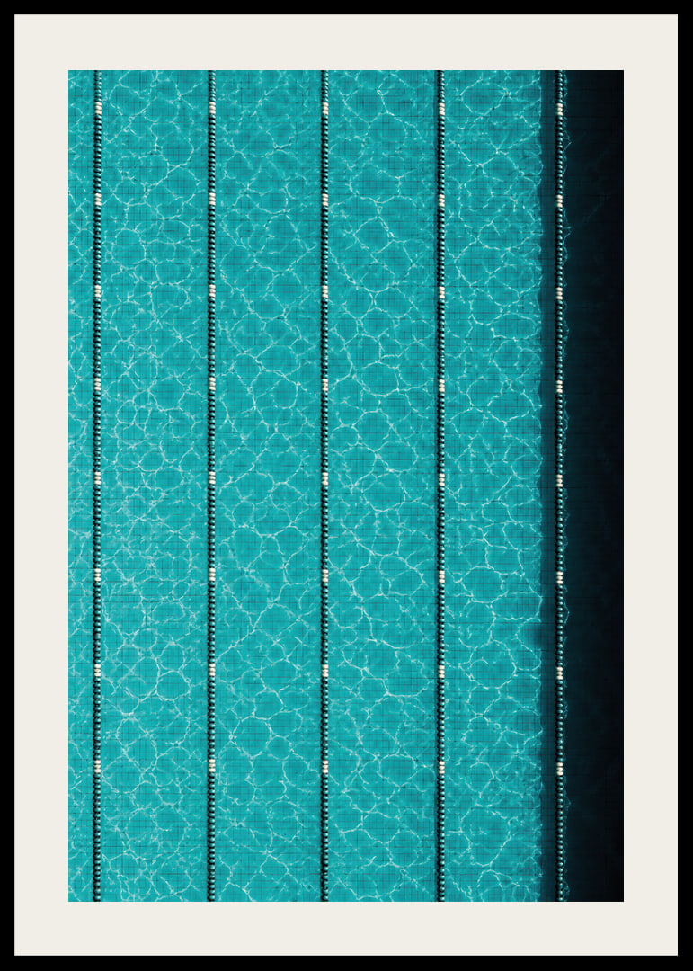 Turquoise pool water and dark track lines create a cool, graphic rhythm.-12