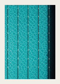 Turquoise pool water and dark track lines create a cool, graphic rhythm.-3