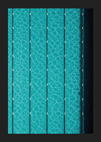 Turquoise pool water and dark track lines create a cool, graphic rhythm.-5