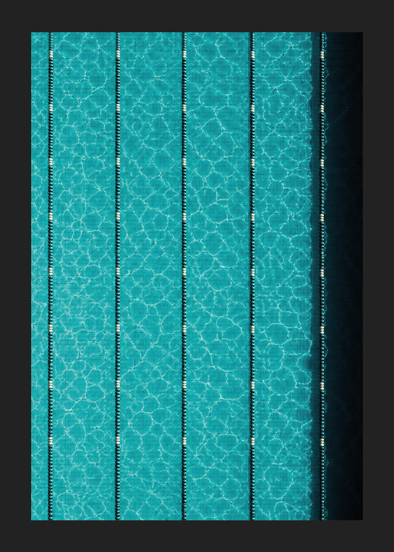 Turquoise pool water and dark track lines create a cool, graphic rhythm.-12