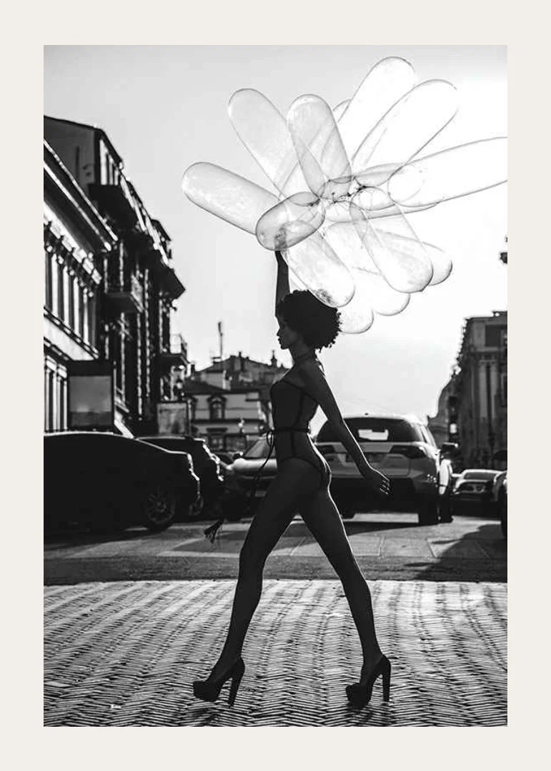 Black and white silhouette of woman with balloons in urban environment-12