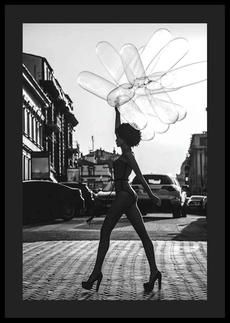 Black and white silhouette of woman with balloons in urban environment-12