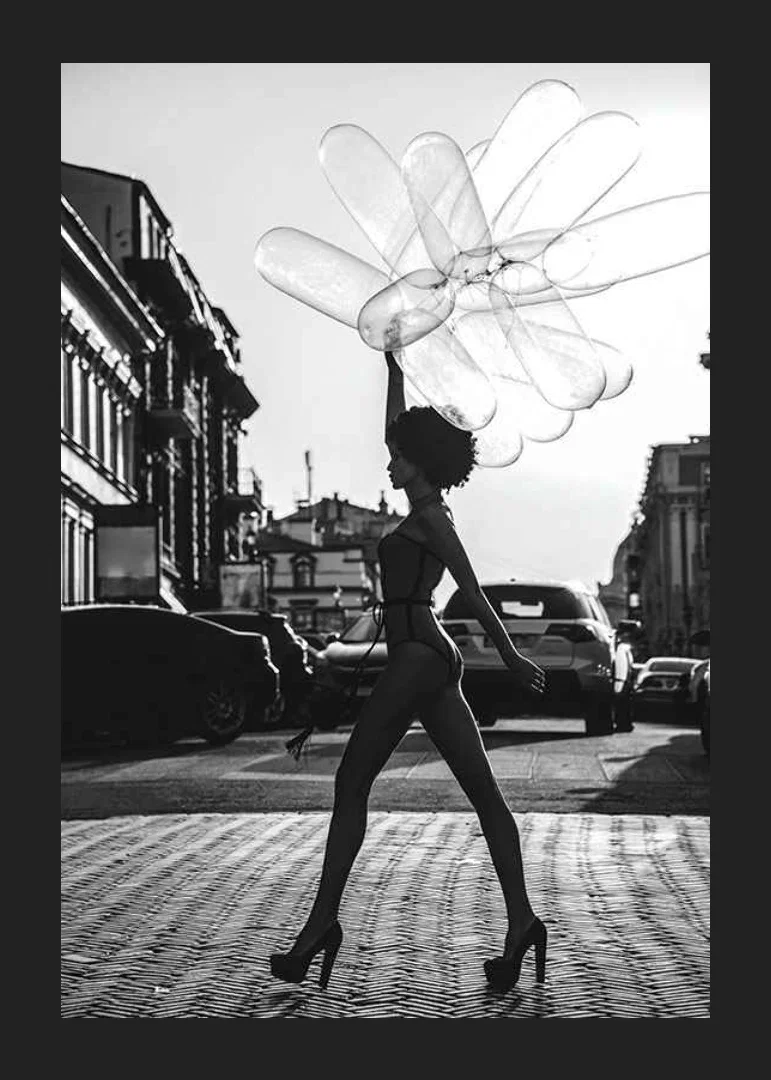 Black and white silhouette of woman with balloons in urban environment-12
