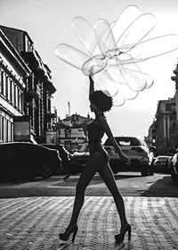 Black and white silhouette of woman with balloons in urban environment-7
