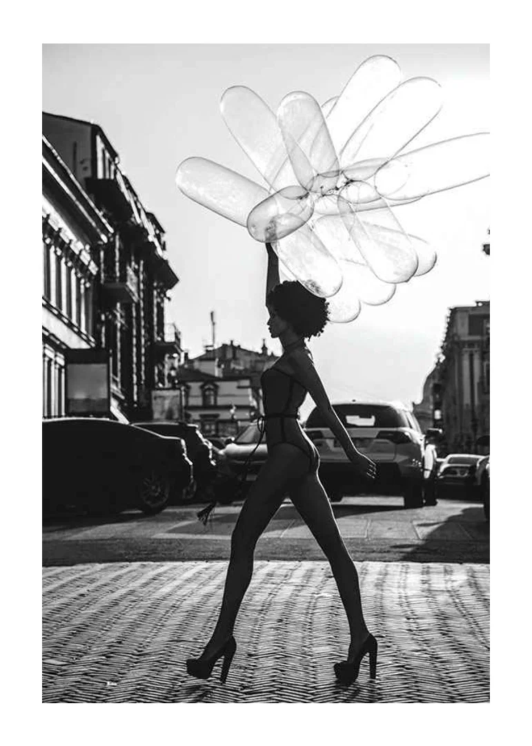 Black and white silhouette of woman with balloons in urban environment-12