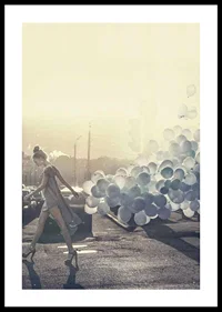 Photograph of woman in gray dress with blue balloons on street-0