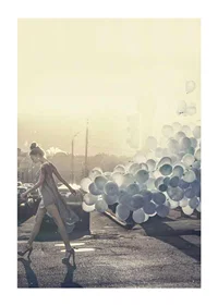 Photograph of woman in gray dress with blue balloons on street-1