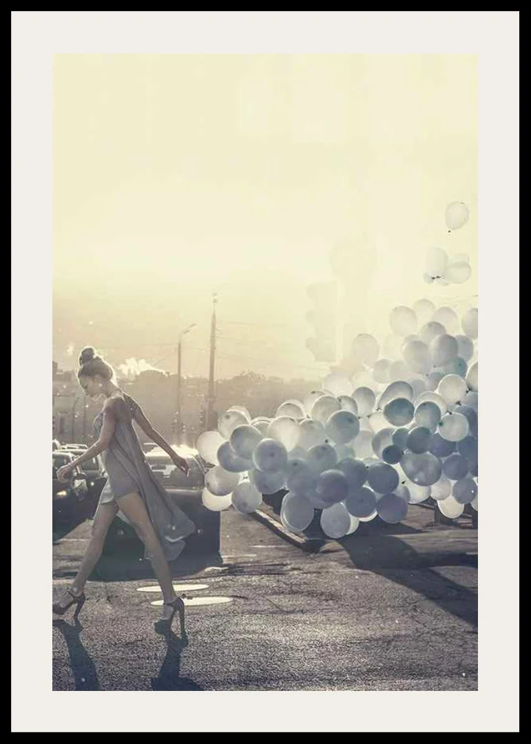 Photograph of woman in gray dress with blue balloons on street-12