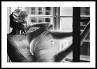 Black and white photograph of woman in lace dress by window-0