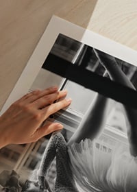 Black and white photograph of woman in lace dress by window-9