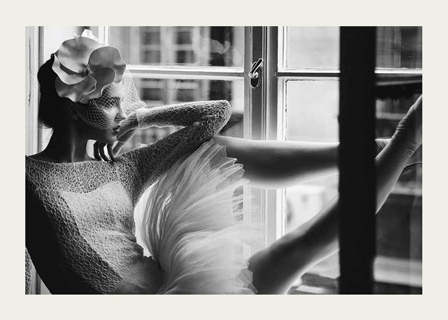 Black and white photograph of woman in lace dress by window-12
