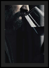 Close-up of man with beard smelling red wine in glass-0