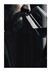 Close-up of man with beard smelling red wine in glass-3