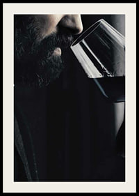 Close-up of man with beard smelling red wine in glass-4