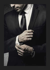 Close-up of man in black suit adjusting cufflinks-1