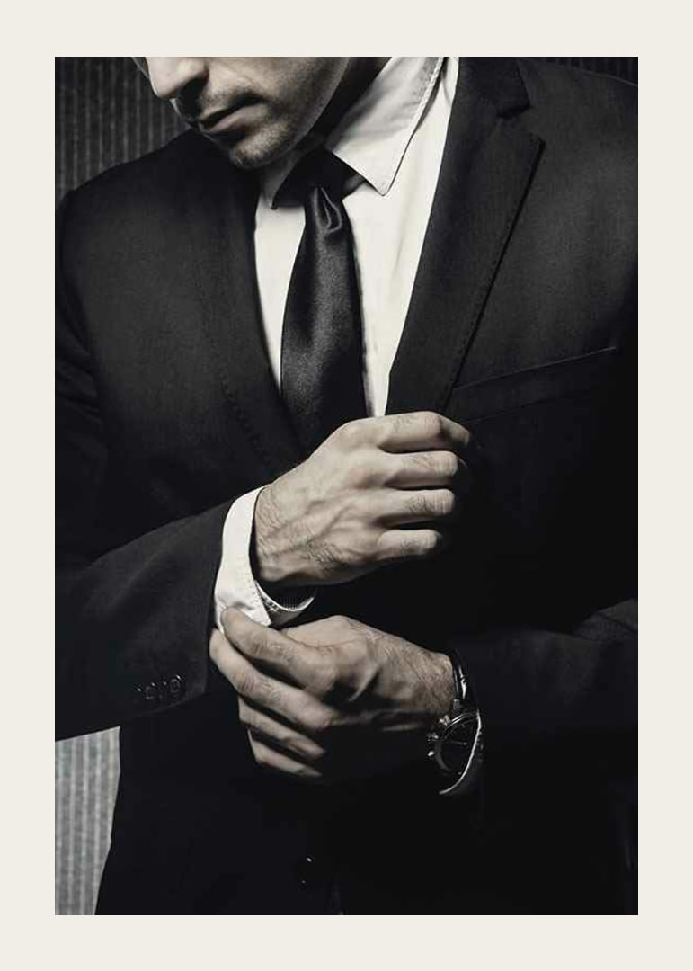 Close-up of man in black suit adjusting cufflinks-12