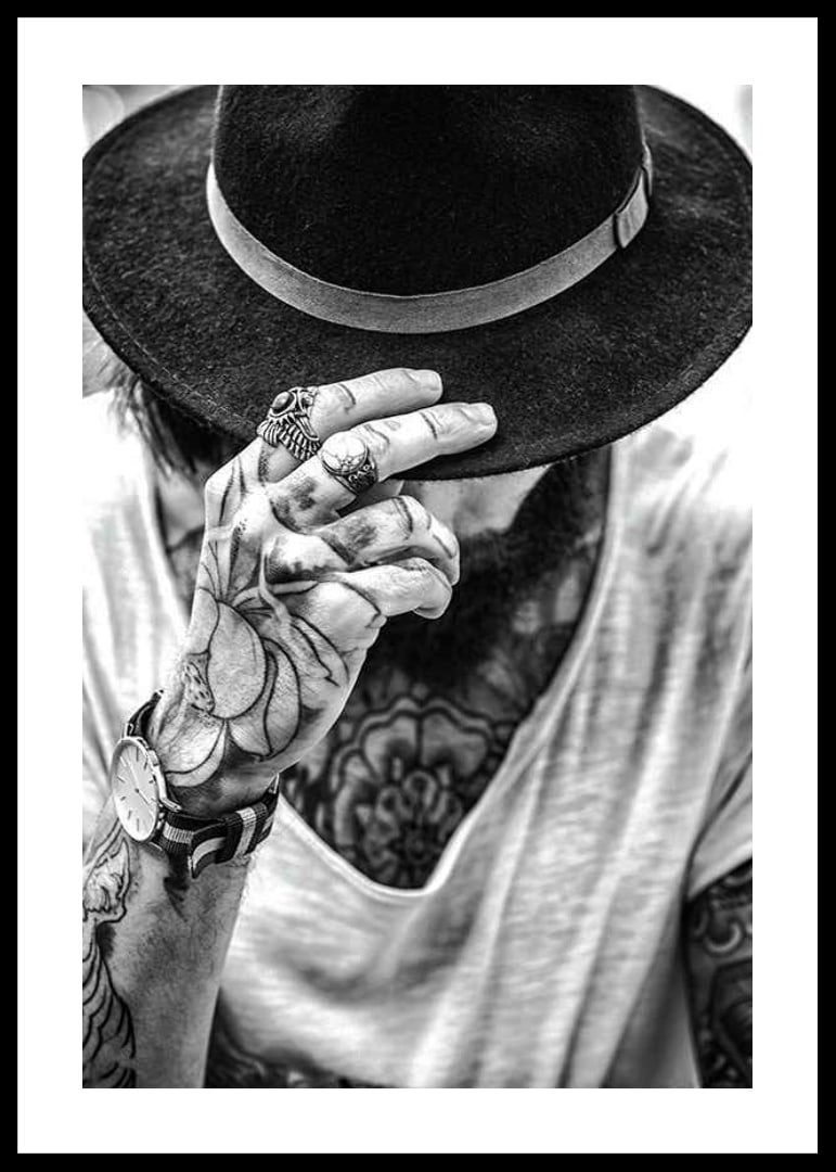 Black and white close-up of tattooed man with hat and jewelry-12