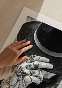 Black and white close-up of tattooed man with hat and jewelry-9
